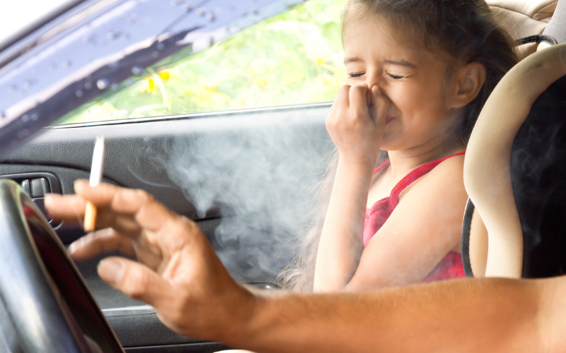 young girl in car suffers effects of secondhand smoke