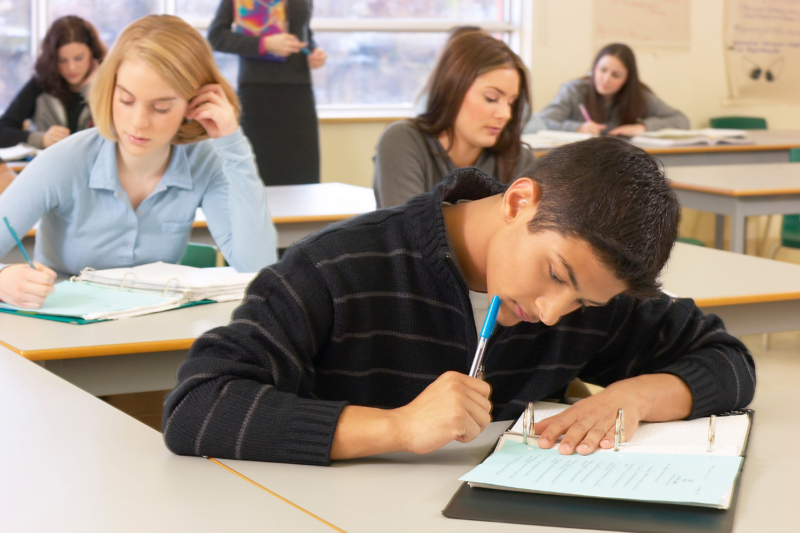 Students in a classroom studying for a test.