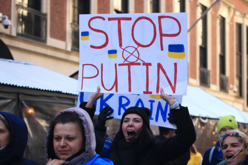 Protest against Putin's actions towards Ukraine, girl holds sign that reads 'stop putin'