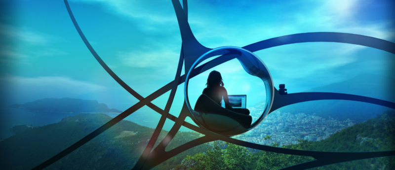 Person at a laptop sitting in a futuristic building surrounded by nature.