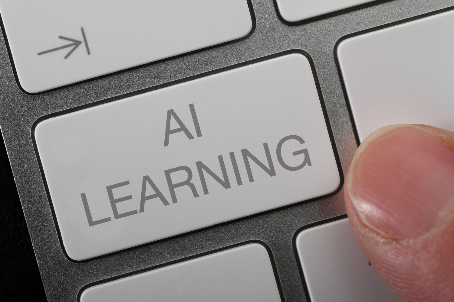 Finger touches a keyboard key that reads "AI Learning"