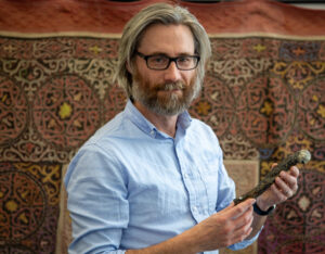 Dr. Alan Turner (Stony Brook University) holding the femur of Labrujasuchus expectatus (photo by James Napoli)