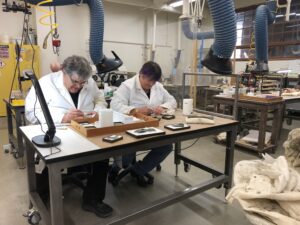 Dinosaur Institute volunteers Richard Hayes and Anne Baker-Hayes preparing Hayden Quarry Ghost Ranch fossils in NHMLAC’s Level 4 Fossil Lab (photo by Nate Smith).