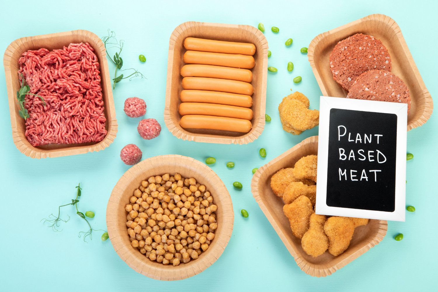 A collection of plant-based meats on top of a blue table.