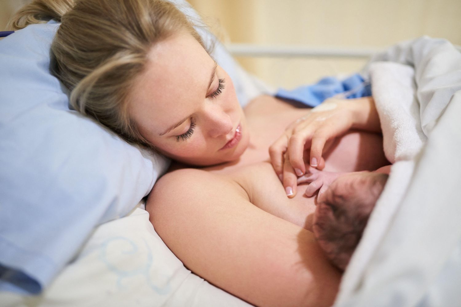 Mother holding child to her.
