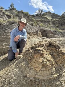 Tyler Lyson with the T. rex trackway, credit Natalie Toth